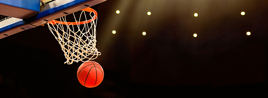 Basketball Through Hoop During College Basketball Game