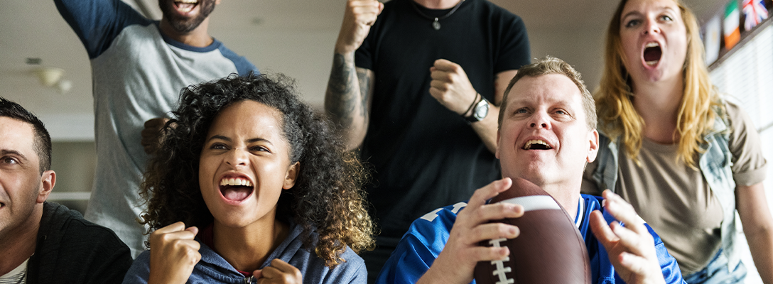 Enthusiastic Pro Football Fans Watching Game